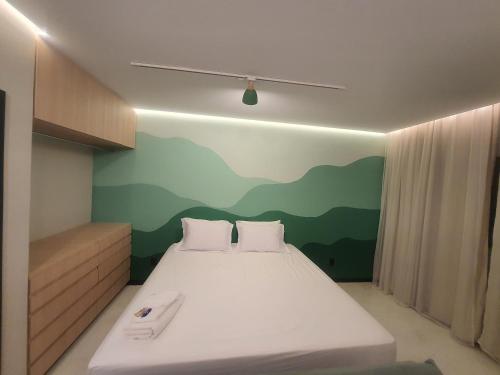 皮乌米Theotokos Flats Apart-hotel的卧室配有一张挂有山壁画的床。