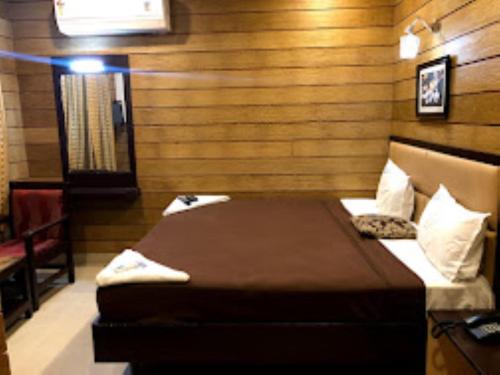 马杜赖Hotel Sri Arulmuthu Residency Madurai的一间小房间,房间内设有一张床