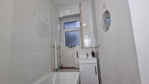 伦敦3 bed flat O2 arena Dyson house的带浴缸、水槽和镜子的浴室