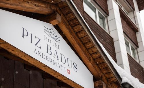 安德马特Hotel Piz Badus的建筑物前方的标志