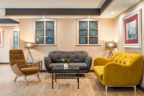 巴塞罗那日光青少年酒店的一间设有两张沙发和一张桌子及椅子的等候室
