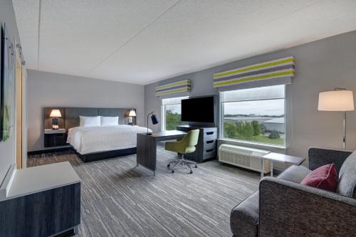 伯灵顿Hampton Inn & Suites Burlington, Ontario, Canada的配有一张床和一张书桌的酒店客房