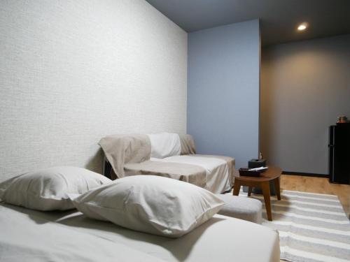 奄美HOOD - Vacation STAY 46460v的客房内的两张床和白色枕头