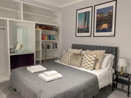 赫尔Cosy 3 bed home with garden - near to uni, restaurants & bars的一间卧室配有一张床,上面有两条毛巾