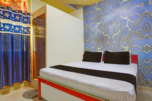 新德里OYO Golden Moment Guest House的一间卧室配有一张蓝色墙壁的床