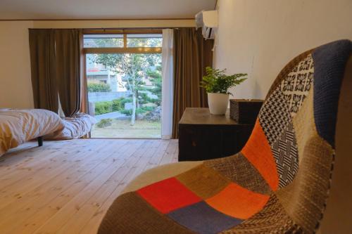 长野Kominkahu kashikiri cottage Tokei - Vacation STAY 57497v的客厅配有椅子和窗户