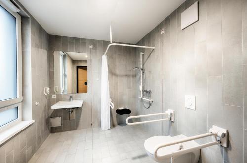 维也纳新村B&B HOTEL Wiener Neudorf的带淋浴、卫生间和盥洗盆的浴室