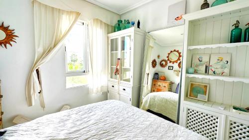 维拉Caroline del Mar - Nudist Naturist的白色的卧室设有床和窗户
