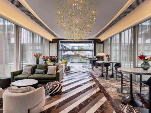 奥克兰索菲特奥克兰高架桥港酒店的酒店大堂设有沙发、桌子和窗户。