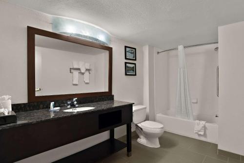 桑蒂桑蒂凯富套房及酒店的一间带水槽、卫生间和镜子的浴室