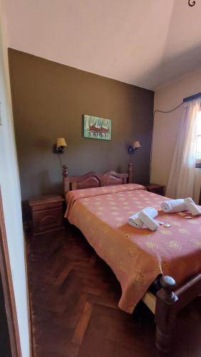 美国别墅城Hotel Lago Los Molinos的一间卧室配有一张带粉红色床罩的床