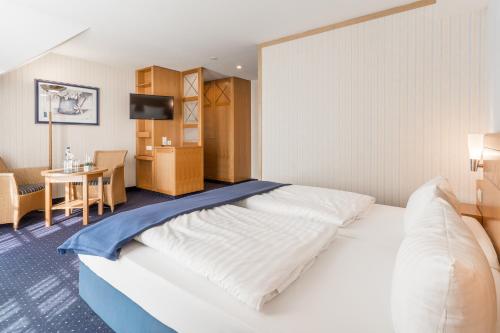巴贝西斯特恩海滨酒店的酒店客房设有一张大床和一张桌子。