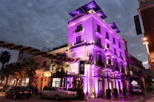 都拉斯Envy Hotel的一座建筑用紫色点亮