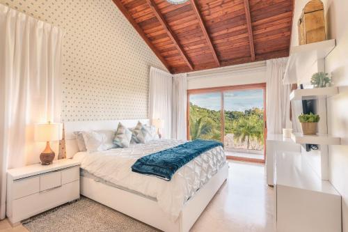 圣塔芭芭拉-山美纳SPECIAL PRICE Puerto Bahia 3BR Villa的卧室设有白色的床和大窗户