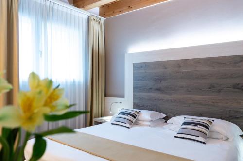 梅斯特亚历山大酒店 的卧室配有带枕头的白色床和窗户。