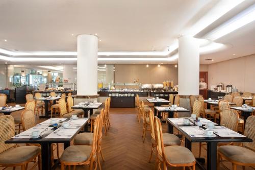里约热内卢科帕卡巴纳温莎怡东酒店的一间带桌椅的用餐室和一间自助餐厅