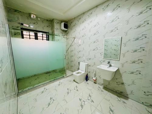 阿布贾Luxury Villa within Abuja Sanctuary的带淋浴、卫生间和盥洗盆的浴室