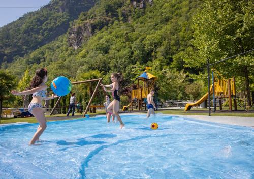 阿韦尼奥Camping Piccolo Paradiso的一群儿童在游泳池玩耍