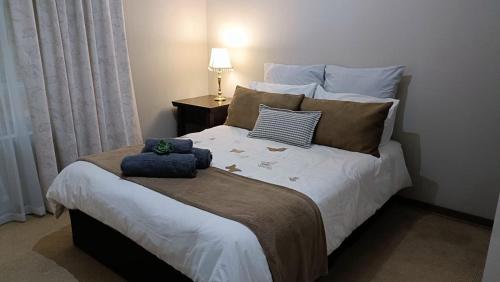 比勒陀利亚741 Tetra Self Catering Accommodation的卧室配有带枕头的大型白色床