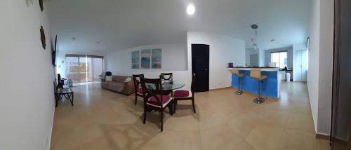 里奥阿托Relajate en un hermoso apartamento Duplex cerca de la playa y piscina en Playa Blanca, Farallon的一个带桌椅的大客厅