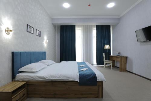 塔什干Cobbler by Resident的一间卧室配有一张大床和电视