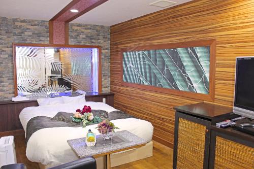 嬉野市パルアネックス鹿島店的酒店客房设有两张床和电视。