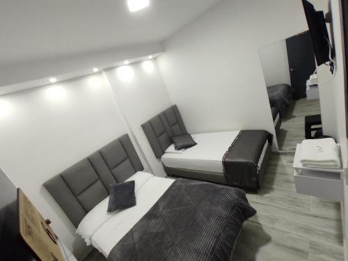 AguadasHotel Casa Blanca的一间客房内配有两张床的房间