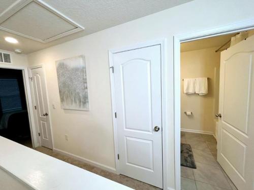 橘园Orange Park Townhome Vacation Rental with Patio!的一间设有浴室的客房内的白色门