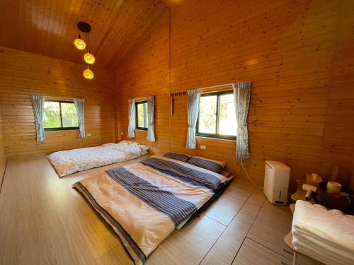 仁爱乡雲熙莊園的配有木墙和窗户的客房内的两张床