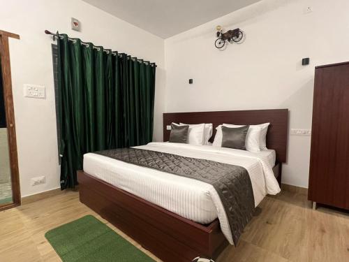 埃尔加德The Clover Resorts的一间卧室配有一张带绿色窗帘的大床