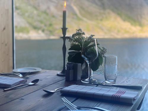 NussfjordLofoten Cottages的一张木桌,上面有蜡烛和蜡烛