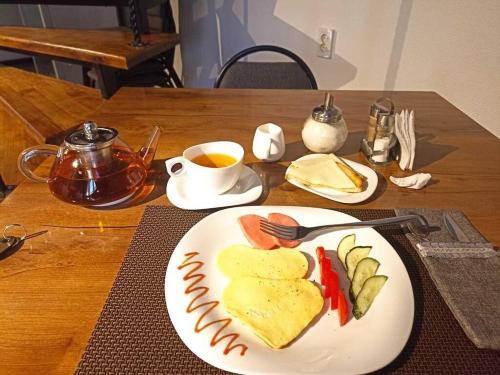 塔拉兹SEQUOIA boutique hotel的餐桌,饭盘,茶杯