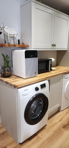 切尔滕纳姆La Casa Rossa - free parking的厨房配有洗衣机和微波炉。