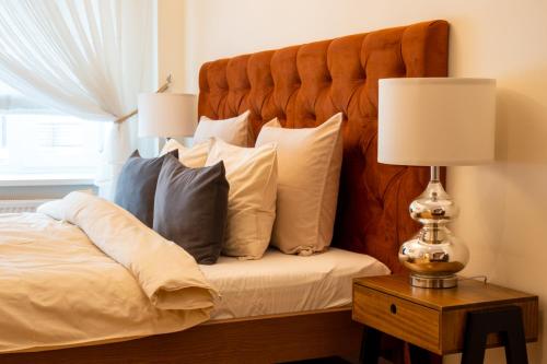 利耶帕亚Design apartment的一间卧室配有带枕头和台灯的床