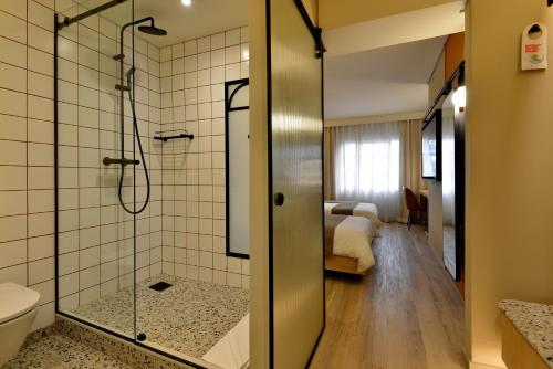 开普敦City Lodge Hotel V&A Waterfront的带淋浴和卫生间的浴室以及一间卧室。