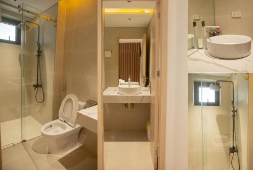 隆海Light House Motel 978的浴室配有卫生间、盥洗盆和淋浴。