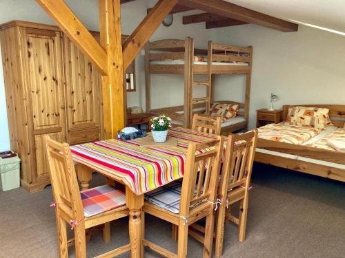 Ubytování v podkroví的客房设有桌椅和双层床。