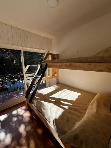 埃博森Travesia Sur Hostel的一间卧室设有一张双层床和大窗户。