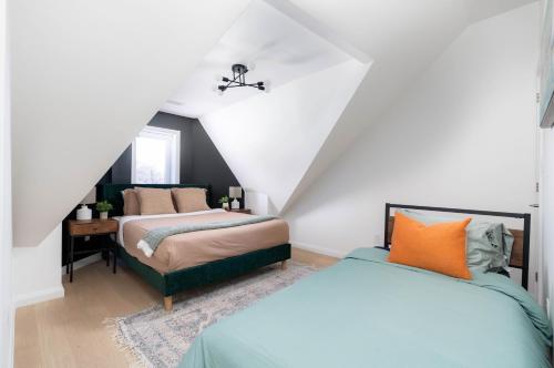 多伦多Luxury 2BD Oasis Steps to Little Italy!的阁楼卧室配有两张床和椅子