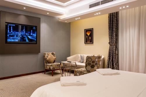 麦地那Nersyan Taiba Hotel Apartments的一间酒店客房,设有两张床和电视