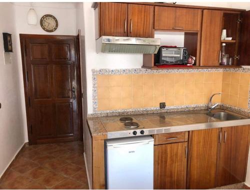 卡博尼格洛Mirador Golf Cabo Negro的厨房配有水槽和炉灶 顶部烤箱