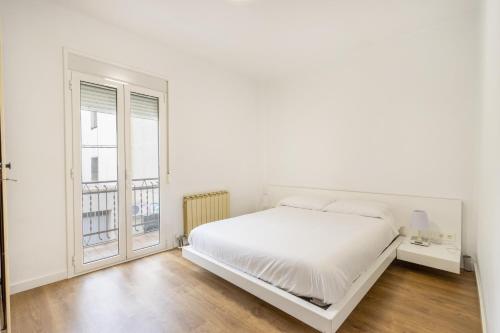 Casa Olegari的白色的卧室设有床和窗户