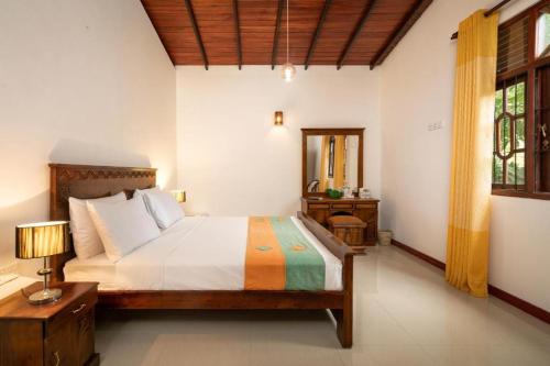 乌纳瓦图纳Star Light Villa的一间卧室,卧室内配有一张大床