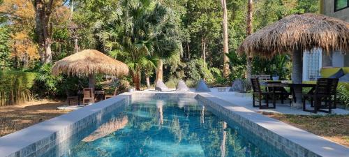 象岛雷兹共和酒店的毗邻度假酒店的带桌椅的游泳池