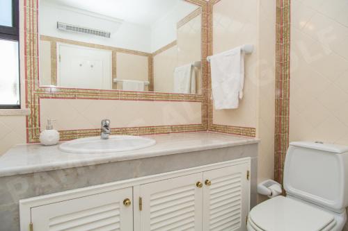 波尔蒂芒Pampas Altogolfe 2 Bedroom Apartment的一间带水槽、卫生间和镜子的浴室
