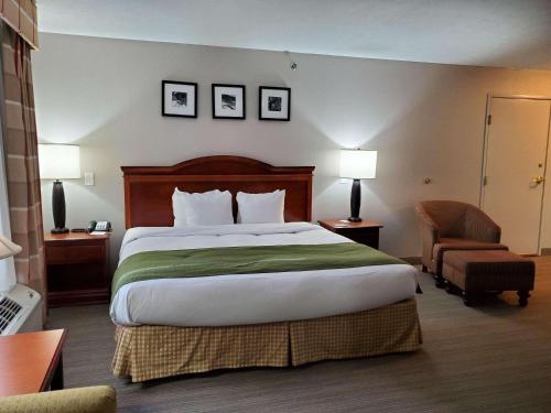帕迪尤卡帕迪尤卡江山旅馆的酒店客房带一张大床和一把椅子
