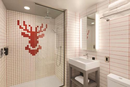 明尼阿波利斯明尼阿波利斯市中心红色丽笙酒店的浴室配有盥洗盆和带镜子的淋浴