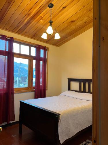 圣胡安拉拉古纳Casa Atitlan I的一间卧室设有一张床和一个窗口