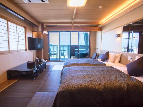 京丹后市LiVEMAX RESORT Kyotango Sea Front的一间卧室配有一张大床和一张沙发