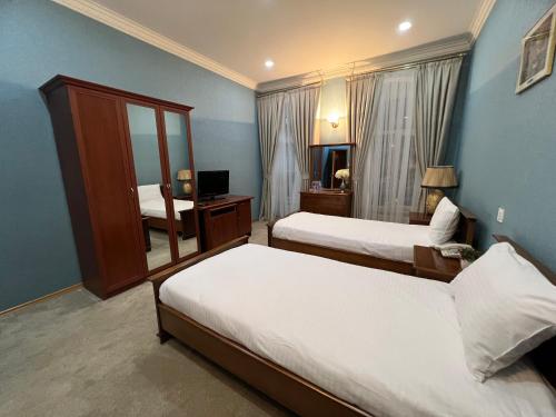 巴库Swan Hotel Baku的酒店客房,设有两张床和镜子